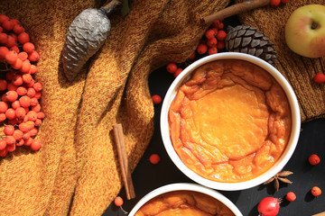 Homemade Pumpkin Souffle. Against an autumn background with a warm sweater, cinnamon sticks,...