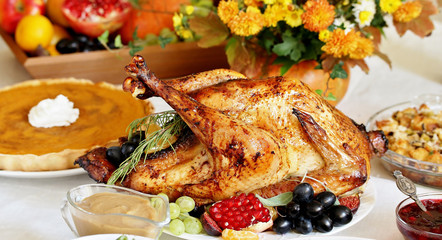 Thanksgiving Day. the traditional dishes for Thanksgiving. young turkey, cranberry sauce, pumpkin pie, stuffing, gravy, mashed potatoes, green beans, pumpkin muffins.