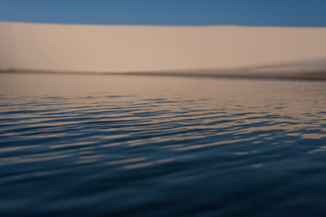 Lençois Maranhenses oasis lake in desert with sand dunes pattern texture