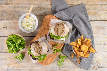 Healthy vegan burger with fresh vegetables and yogurt sauce