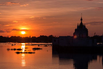 Fototapeta na wymiar Temple in the lake at sunset scene in Mandalay, Myanmar