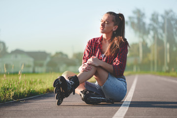 Woman injured knee while rollerblading. A teenager having a bruise after falling while inline...