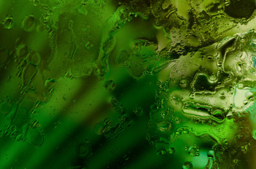 Beautiful liquid background. Background with different drops. Green and aqua elements.
