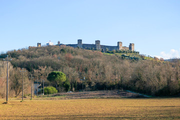 Panoramic winter view to medieval tuscany town Monteriggioni with wall and towers