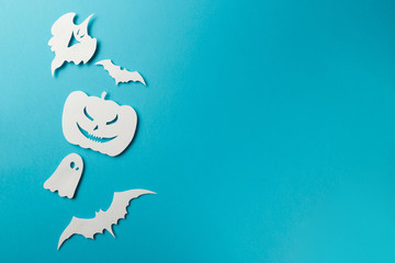 Halloween decorations. Halloween paper decorations on pastel blue background. Top view. Flat lay of accessory decoration Halloween festival. Copy space. Minimal creative concept. Pastel colors
