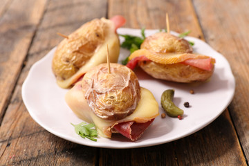 potato with cheese melted and salami