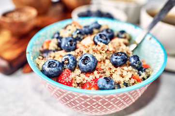 Quinoa with blueberries and strawberries for breakfast. Modern trends in healthy eating