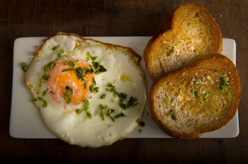 Fried egg with two bread toasts