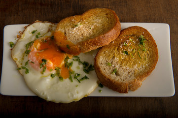 Fried eggs with bread toasts