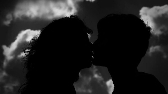 young couple in black and white kissing. Romanticism, love, tenderness