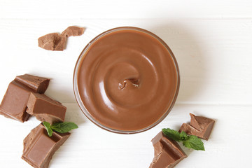 chocolate cream on a colored background top view. chocolate butter, chocolate paste.