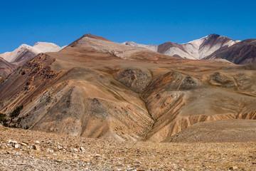 Russia. Altai. Kurai ridge. Multicolor slopes of the mountains, brown and yellow shades.