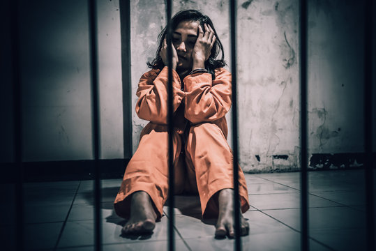 Portrait of women desperate to catch the iron prison,prisoner concept,thailand people,Hope to be free,If the violate the law would be arrested and jailed.