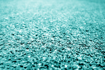 Artificial grass with blur effect in cyan tone.