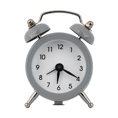 A gray clock with an alarm clock on a white background with arrows showing the time six hours twenty minutes or eighteen hours twenty minutes