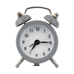 A gray clock with an alarm clock on a white background with arrows showing the time seven hours fifteen minutes or nineteen hours fifteen minutes