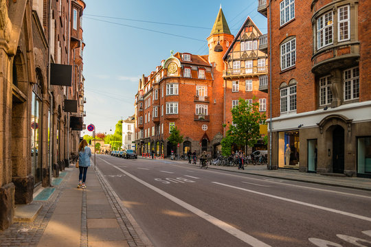 Street life in Copenhagen. People walking, riding bikes in the city center
