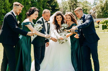 Beautiful young people holding glasses of champagne in their hands.