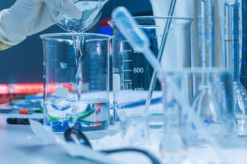 Scientist mix chemicals with The shake machine Before the experiment.Mixture laced with samples into test tubes,Thailand scientist working in the lab