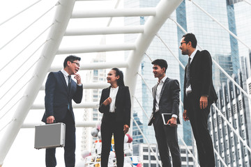 Asian Businessmen Group Planning meetings together outside the workplace and enjoying the successful results, concept to teamwork and synergy concept.