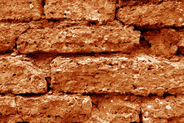 Old grungy brick wall texture in orange tone.