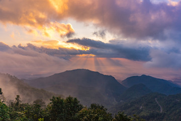 Impressive scenery sunset in the mountains with fog