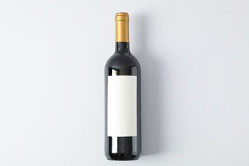 Bottle of red wine on grey background, space for text