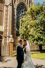 Cute couple posing on church background