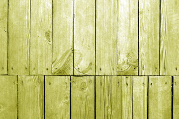 Old grungy wooden planks background in yellow tone.