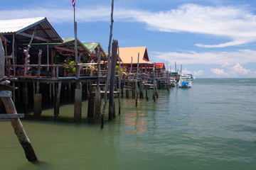 Scenery sea view with cafes and restaurants by the water. Coastline seafood restaurants and boats in Koh Phangan, Thailand.