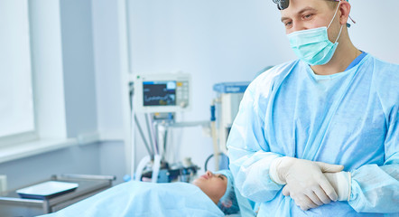 Several doctors surrounding patient on operation table during t