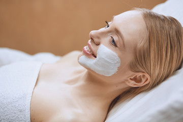 Beautiful young woman in cosmetic salon close up