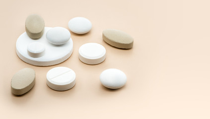 Obraz na płótnie Canvas Various pharmaceutical medicine pills and tablets close-up on a soft beige background. Healthcare and pharmaceuticals. Pills background, copy space.