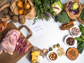 Healthy food rich in amino acids, for body builders with meat, salmon fish, nuts, cheese, eggs, seeds, beans, vegetables, herbs, spinach, garlic, grains on white background