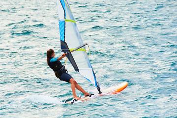 Windsurfing on Lake Garda. Unidentifiable Windsurfer Surfing The Wind On Waves, Recreational Water...