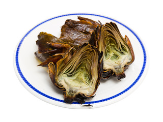Delicious fried artichoke halves on a white plate