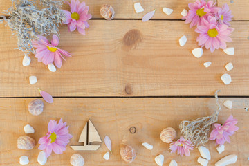 Beautiful flowers and sea decor on wooden background