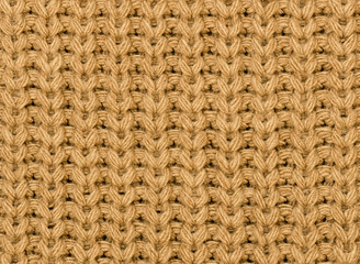 Knitted fabric texture in autumn color. Abstract background. Close-up.