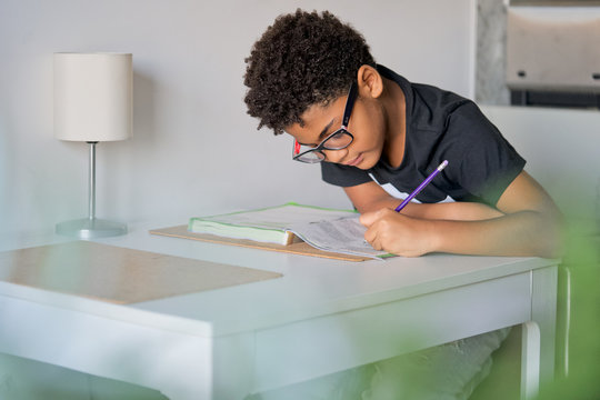 Kid doing homework at the Kitchen table