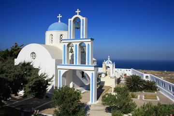 Beautiful blue and white church on the hill, visible against the blue sky, Santorini island, Greece