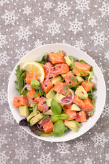 festive salad with salmon, avocado, onion and basil