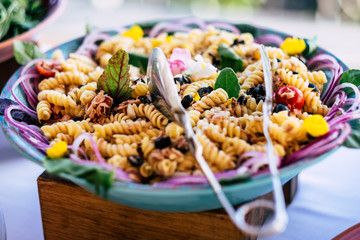 Close up of fresh and tasty italian pasta meal food - concept of restaurant and catering service for event or party celebration -carbo diet and happiness