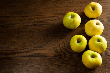 green apples on a wooden table
