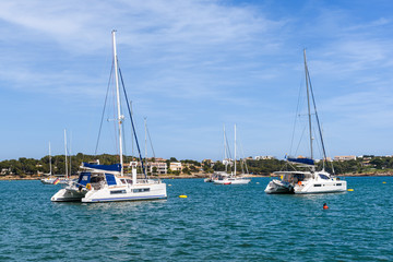 Fototapeta na wymiar Yachts in the port of Portocolom located in the southeast at the coast of Majorca. Spain