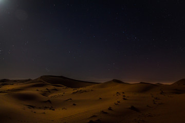Obraz na płótnie Canvas Night landscape. Dunes in the Sahara Desert by Moonlight