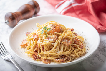 carbonara spaghetti with raw egg yolk on top