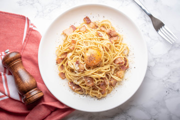 carbonara spaghetti with raw egg yolk on top