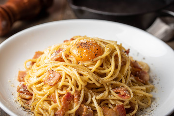 carbonara spaghetti with raw egg yolk on top