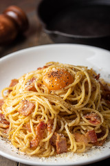 carbonara spaghetti with raw egg yolk on top