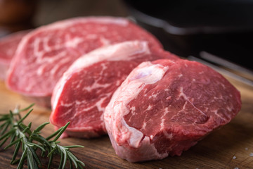 raw beef tenderloin on wooden cutting board